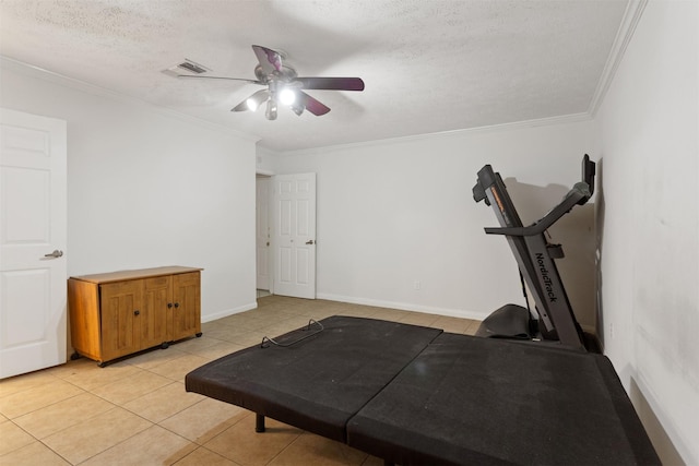 exercise room featuring crown molding, ceiling fan, light tile patterned flooring, and a textured ceiling