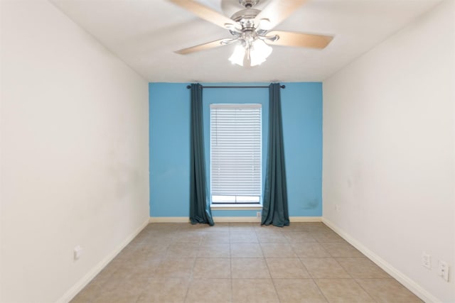 tiled spare room with a wealth of natural light and ceiling fan