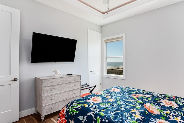 bedroom with ceiling fan, ornamental molding, and dark wood-type flooring