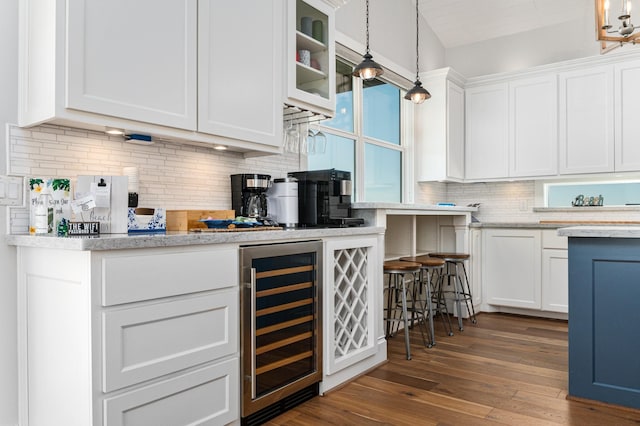 kitchen with backsplash, pendant lighting, white cabinets, dark hardwood / wood-style floors, and wine cooler