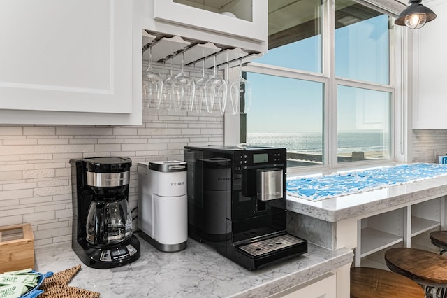 room details with decorative backsplash and white cabinets