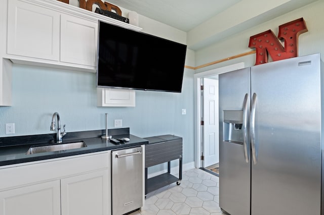 kitchen with white cabinetry, stainless steel fridge with ice dispenser, sink, and light tile patterned flooring