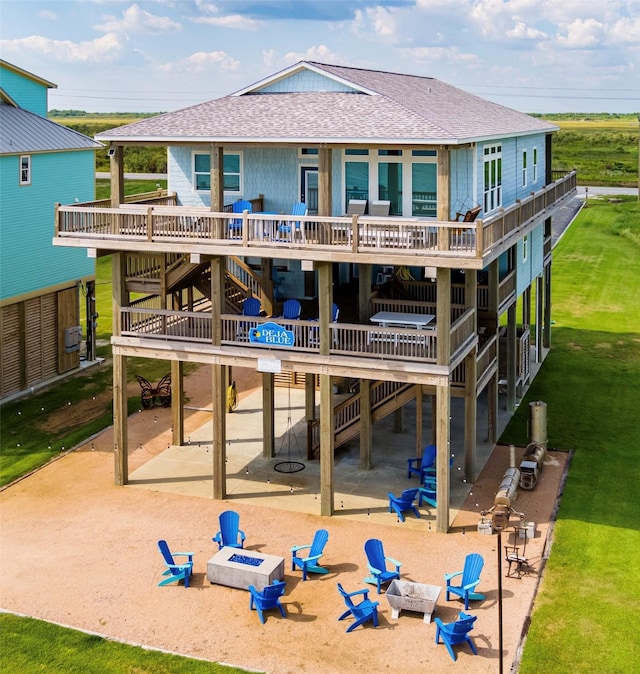 rear view of house featuring a patio, a fire pit, and a wooden deck