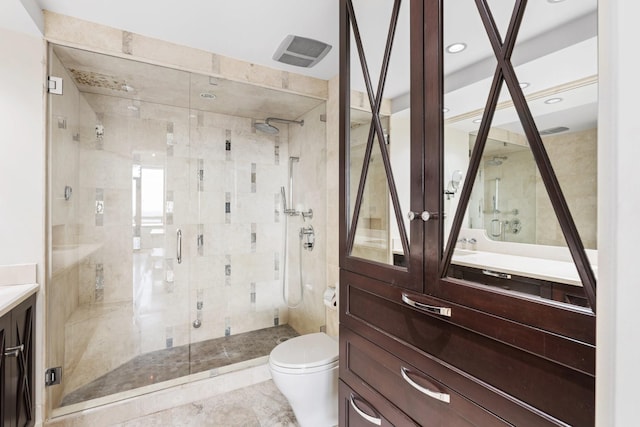 bathroom featuring vanity, toilet, and walk in shower