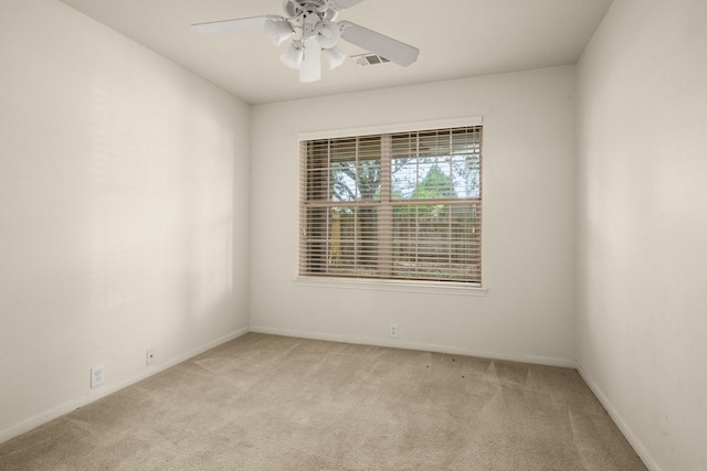 carpeted spare room with ceiling fan