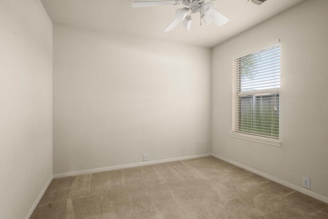 spare room featuring light carpet and ceiling fan