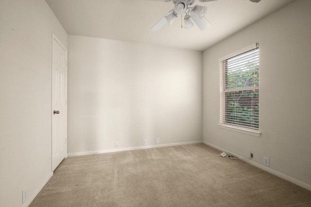 unfurnished room with ceiling fan and light carpet