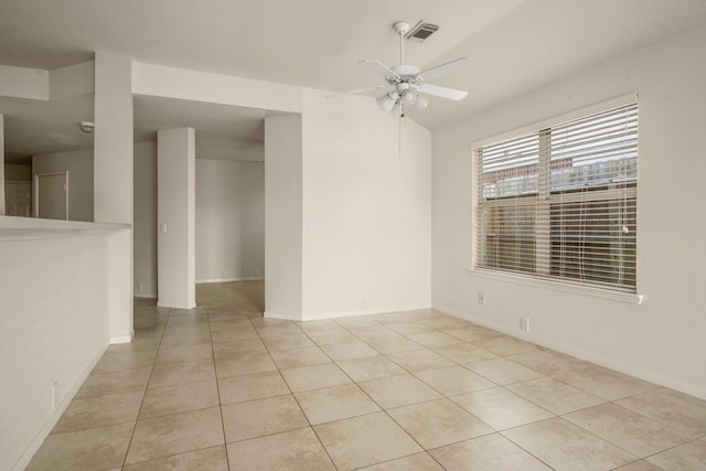 spare room featuring ceiling fan and light tile patterned floors