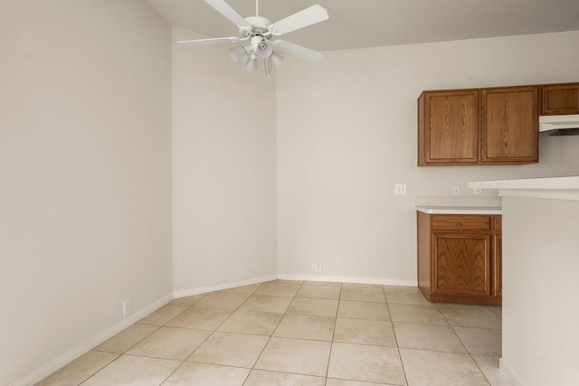 interior space featuring light tile patterned floors and ceiling fan