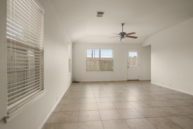 empty room featuring ceiling fan, light tile patterned floors, and lofted ceiling