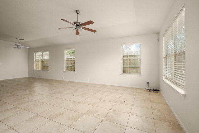 empty room featuring ceiling fan and light tile patterned floors