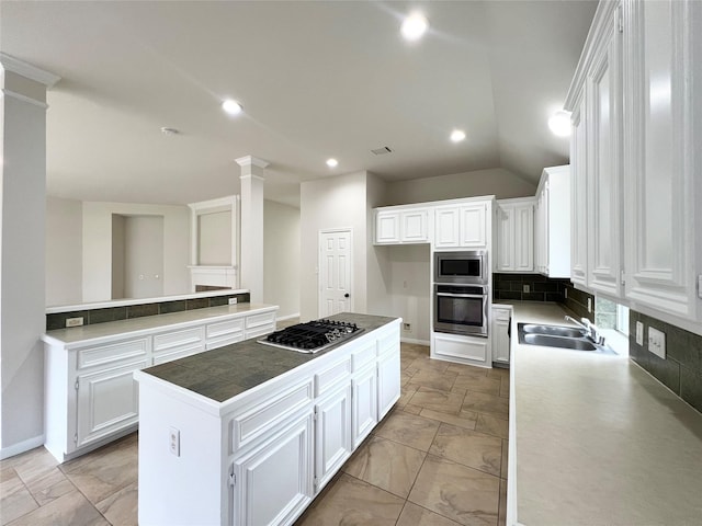 kitchen featuring white cabinets, a kitchen island, and appliances with stainless steel finishes