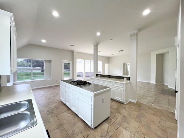 kitchen featuring vaulted ceiling, white cabinetry, plenty of natural light, and stainless steel gas cooktop