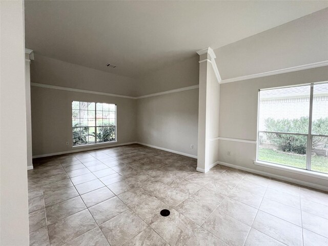 spare room featuring light tile patterned flooring and ornamental molding