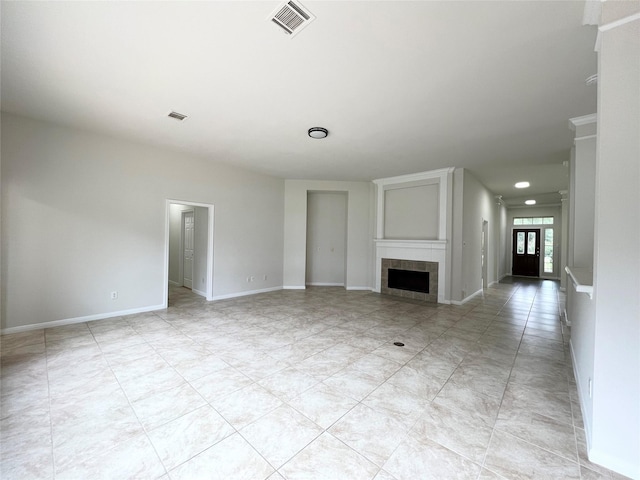 unfurnished living room featuring a tiled fireplace