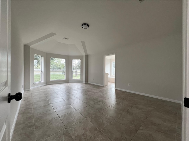 empty room featuring dark tile patterned floors