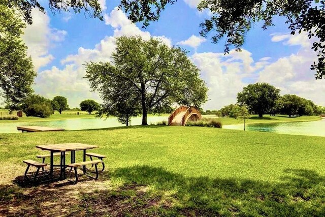 view of property's community with a lawn