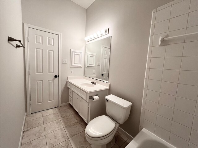 bathroom featuring tile patterned flooring, vanity, toilet, and a bathtub