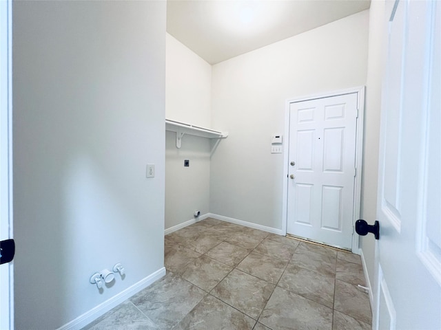 clothes washing area featuring hookup for a gas dryer, light tile patterned flooring, and hookup for an electric dryer