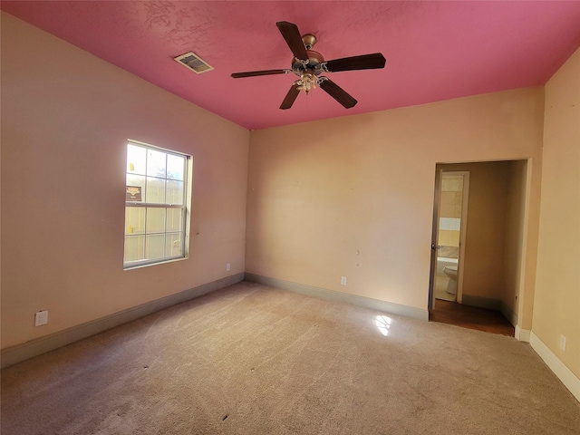 carpeted spare room with ceiling fan