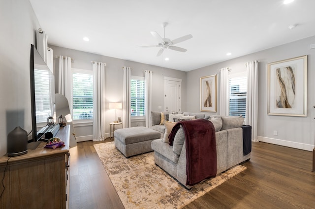 living room with dark hardwood / wood-style floors and ceiling fan