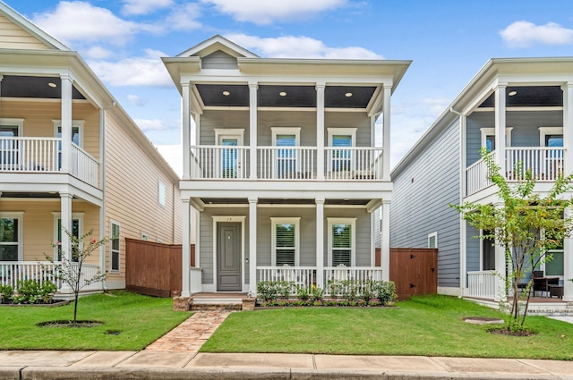 view of front of property with a balcony and a front yard