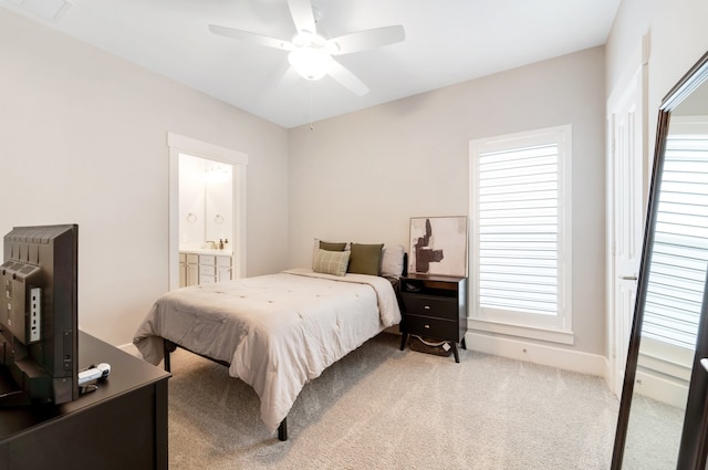 carpeted bedroom with connected bathroom and ceiling fan