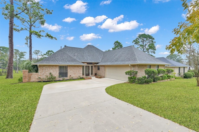 view of front of home with a garage and a front lawn