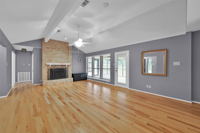 unfurnished living room featuring ceiling fan, light hardwood / wood-style flooring, lofted ceiling with beams, and a brick fireplace