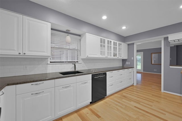 kitchen featuring black dishwasher, light hardwood / wood-style floors, white cabinetry, and sink