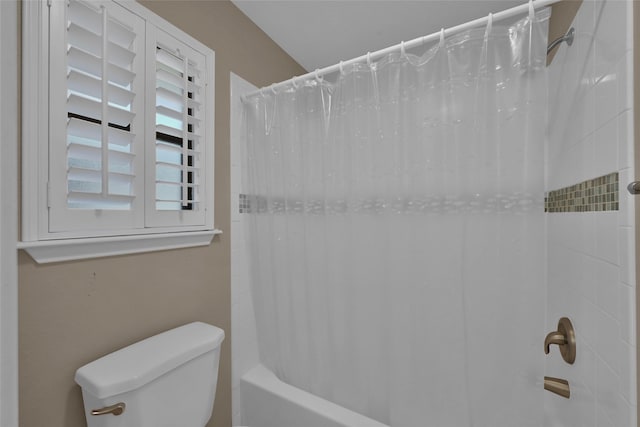 bathroom featuring shower / bathtub combination with curtain and toilet