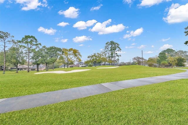 view of home's community featuring a lawn