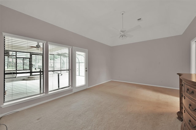 interior space featuring ceiling fan and light colored carpet