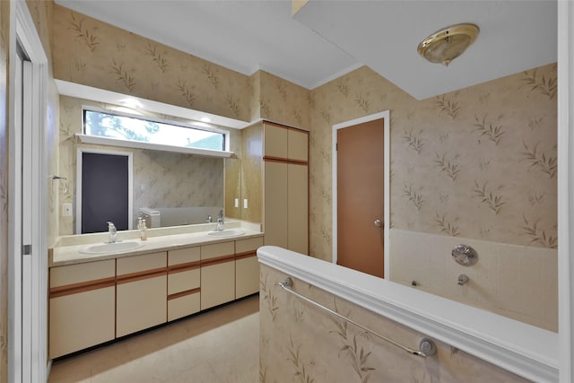 bathroom featuring tile patterned floors, vanity, and tiled tub