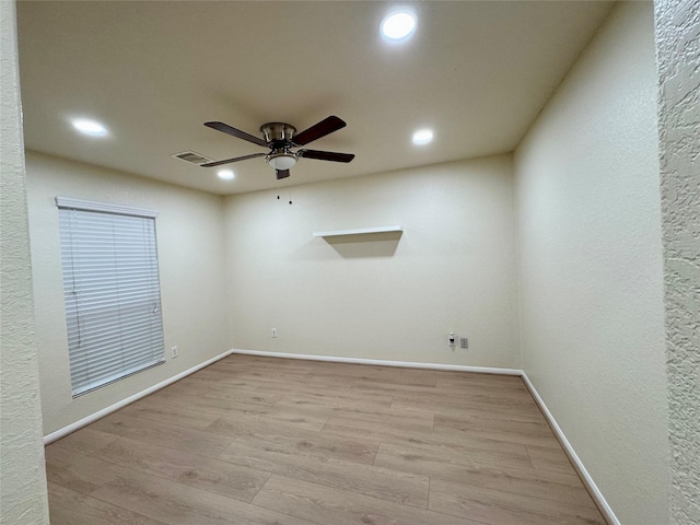 spare room featuring ceiling fan and light hardwood / wood-style flooring