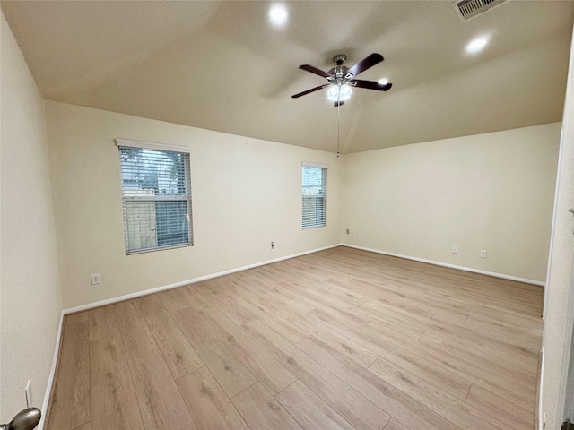 spare room featuring plenty of natural light, light hardwood / wood-style floors, lofted ceiling, and ceiling fan