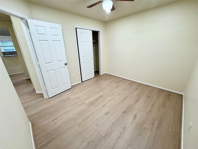 unfurnished bedroom featuring ceiling fan and light wood-type flooring