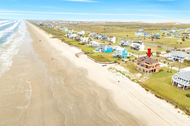 bird's eye view with a water view and a beach view