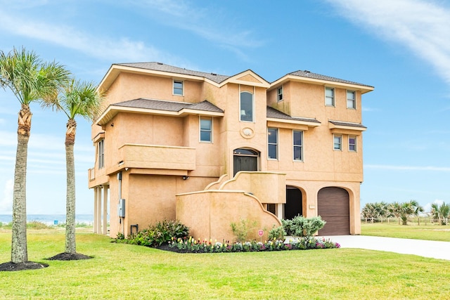 view of front of house with a garage and a front yard