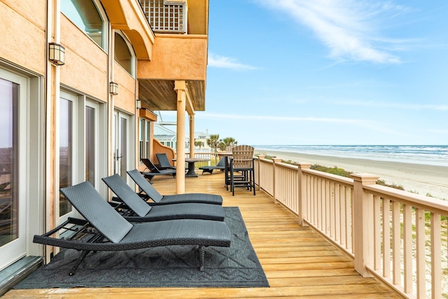 balcony featuring a water view and a view of the beach