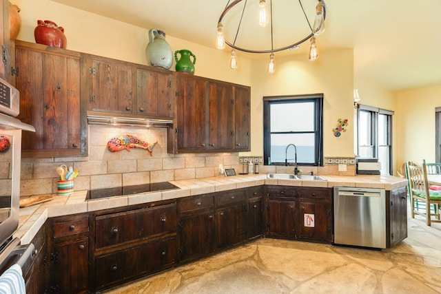 kitchen with tile countertops, sink, and stainless steel appliances