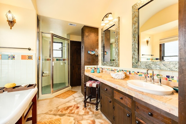 bathroom with a shower with door and vanity