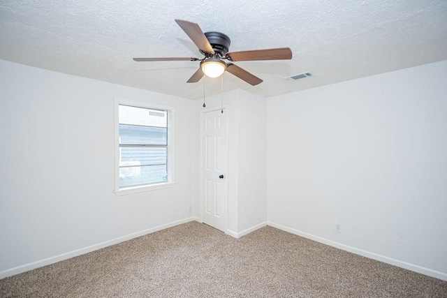 unfurnished room featuring carpet flooring, a textured ceiling, and ceiling fan