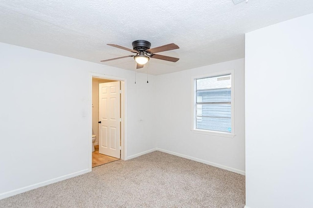 carpeted empty room featuring a textured ceiling and ceiling fan