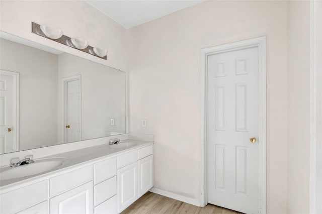 bathroom with hardwood / wood-style floors and vanity