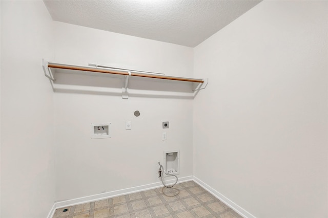 laundry room with hookup for a washing machine, a textured ceiling, gas dryer hookup, and electric dryer hookup