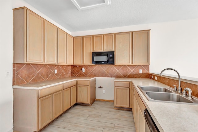 kitchen with light brown cabinetry, light wood-type flooring, tasteful backsplash, a textured ceiling, and sink