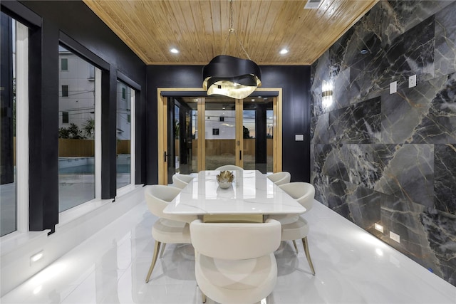 dining room with wood ceiling and tile walls