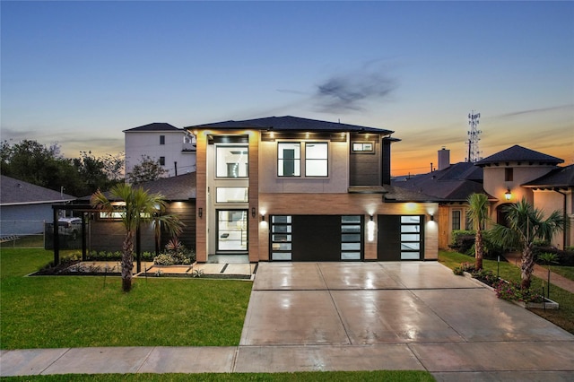 view of front of property featuring a yard and a garage