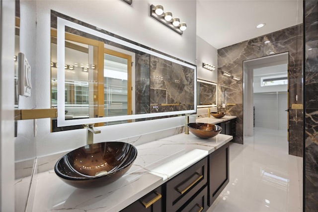 bathroom with vanity and tile walls